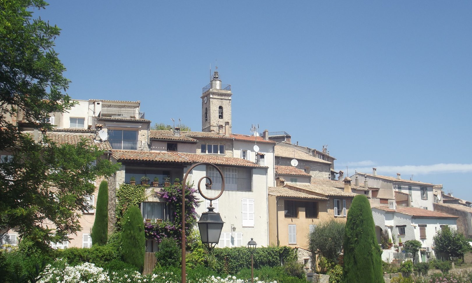 Stone facades and flowered lane in the village of Mougins